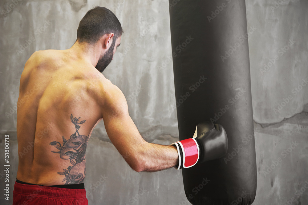 Boxer man doing exercise with punching bag Boxer man doing exercise with punching bag