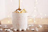 coffee with whipped cream, marshmallow and caramel topping