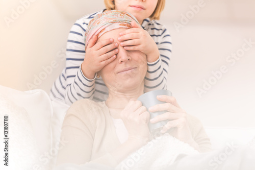 Child playing with ill mother