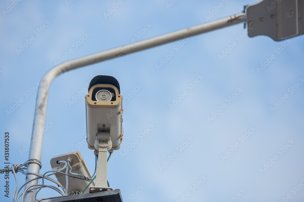 Security camera on blue sky background