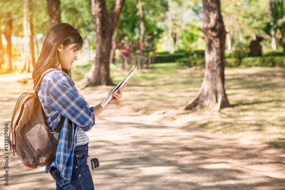 Woman reading a map in the forest Woman reading a map in the forest
