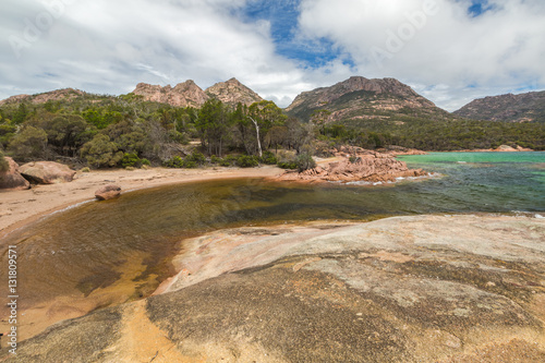 Honeymoon Bay is located near Coles Bay in the Freycinet Peninsula.The Freycinet National Park,is a paradise of pink granite mountains,white beaches and turquoise sea on Tasmanias east coast,Australia