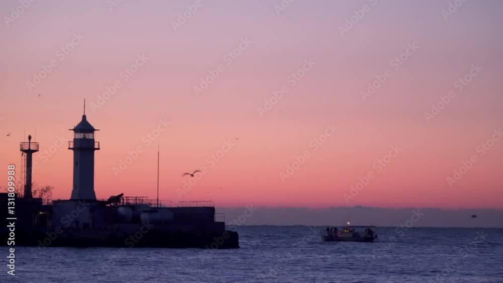 Flashing Beacon at dawn. Nearby you can see the fishing boat Flashing Beacon at dawn. Nearby you can see the fishing boat