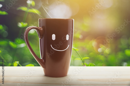 Obraz na plátně Brown mug of coffee with a happy smile
