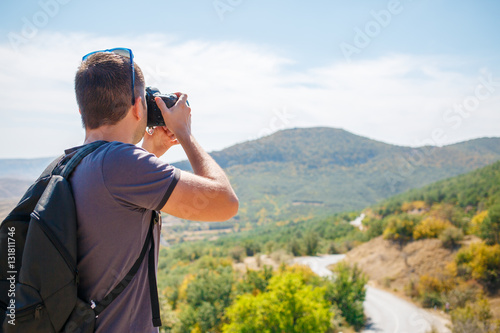 Guy taking pictures of mountain