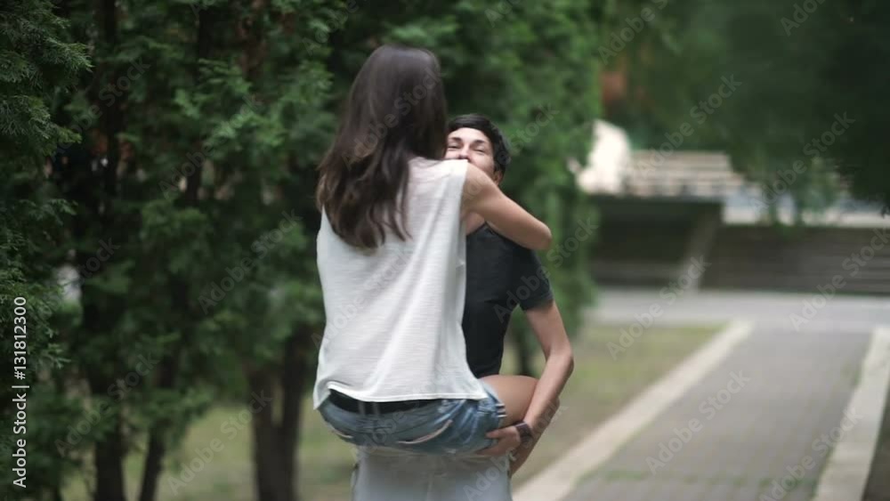 Woman holds in arms her girlfriend and turn around Woman holds in arms her girlfriend and turn around