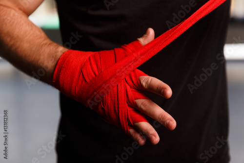 Sportsman wears red boxing bandages