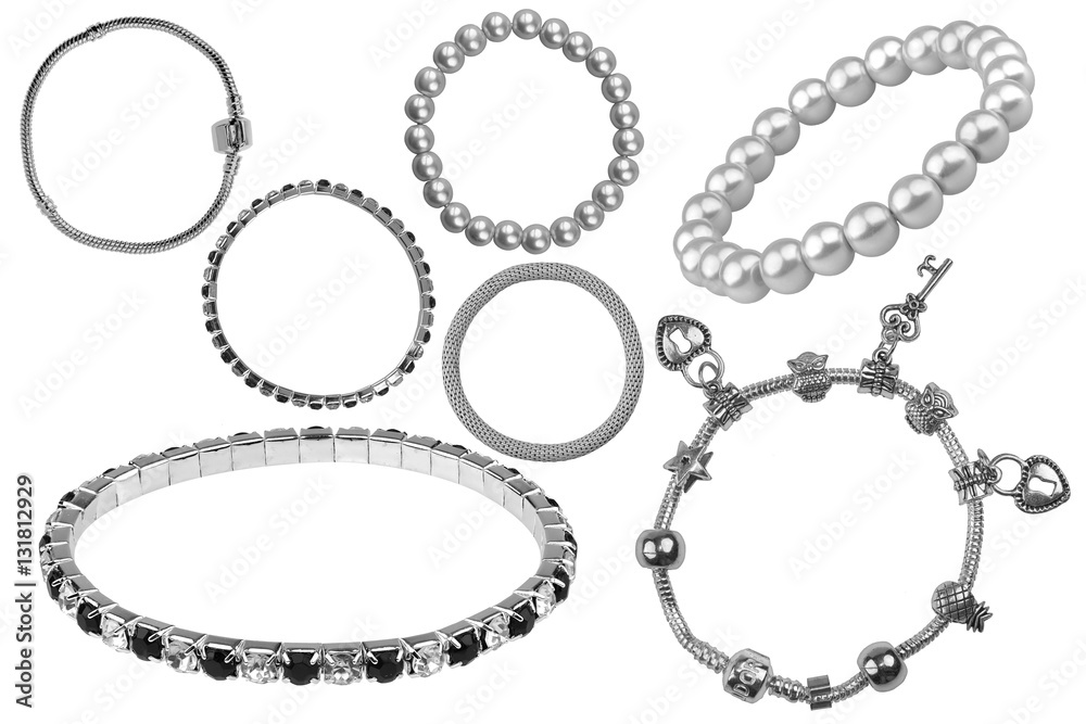 Group of many elegant silver and metallic bracelets, with precious stones and little charms, isolated on white background, clipping paths included Group of many elegant silver and metallic bracelets, with precious stones and little charms, isolated on white background, clipping paths included