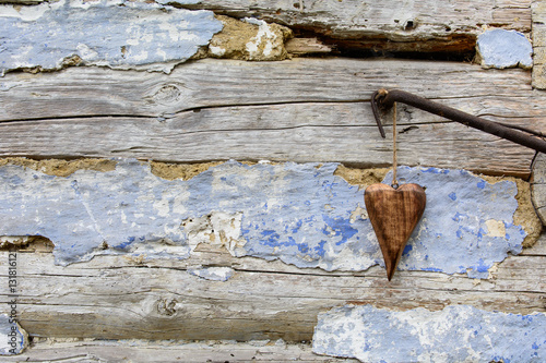 Wooden heart on a background of the old wall