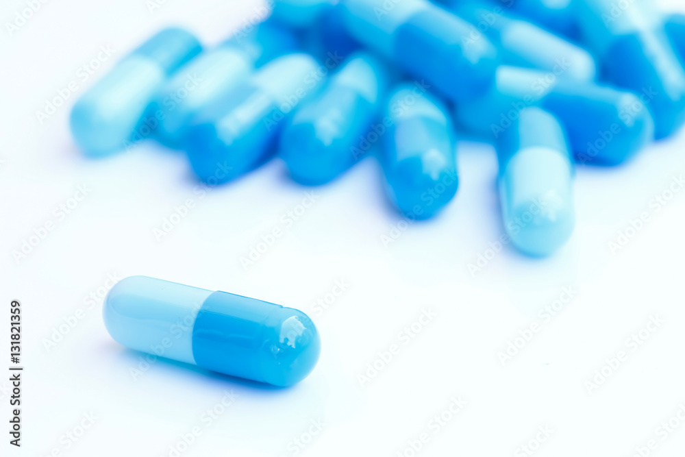 close up of blue medical capsules isolated on white background close up of blue medical capsules isolated on white background