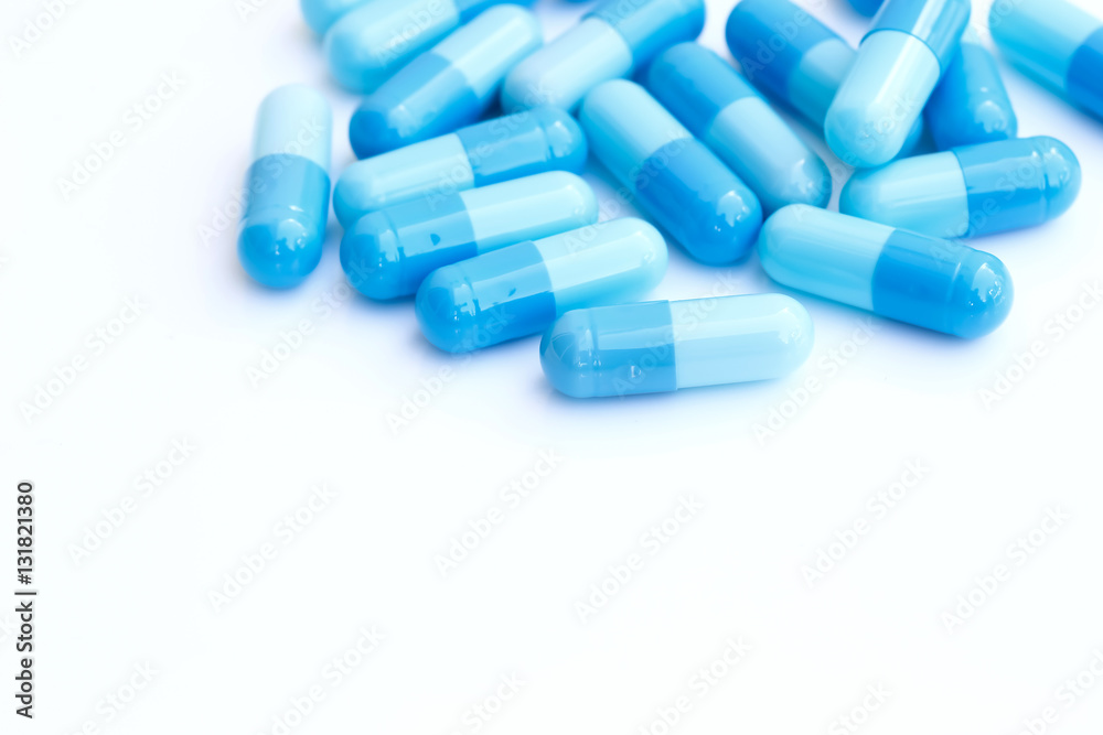close up of blue medical capsules isolated on white background close up of blue medical capsules isolated on white background