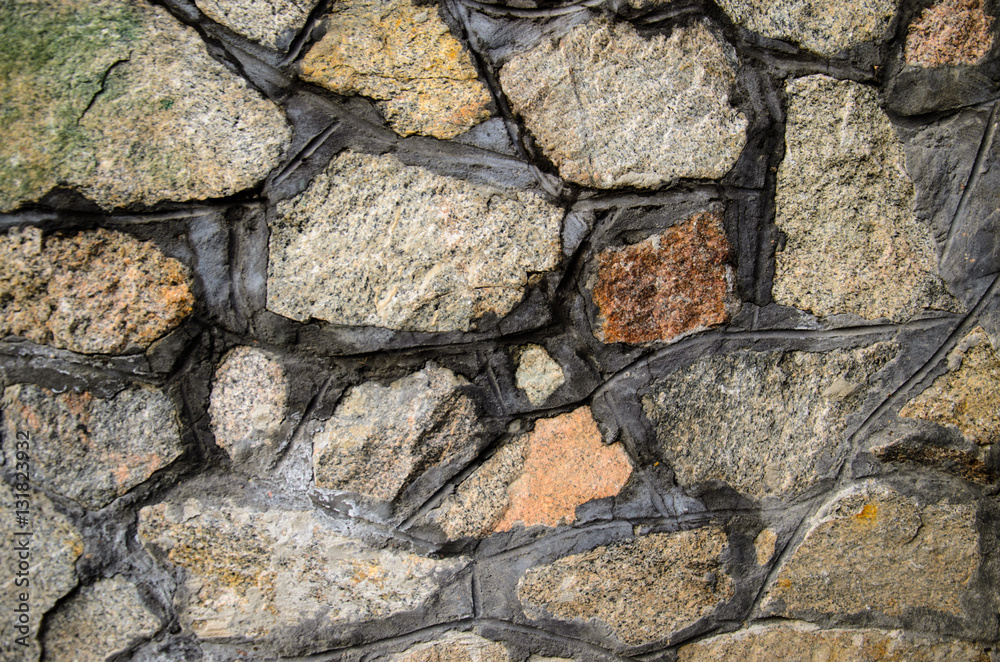 Texture of granite stone wall as a background