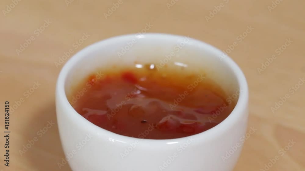 Dipping Chicken Crossie into Sweet Chilli Sauce, Closeup, low focus Dipping Chicken Crossie into Sweet Chilli Sauce, Closeup, low focus