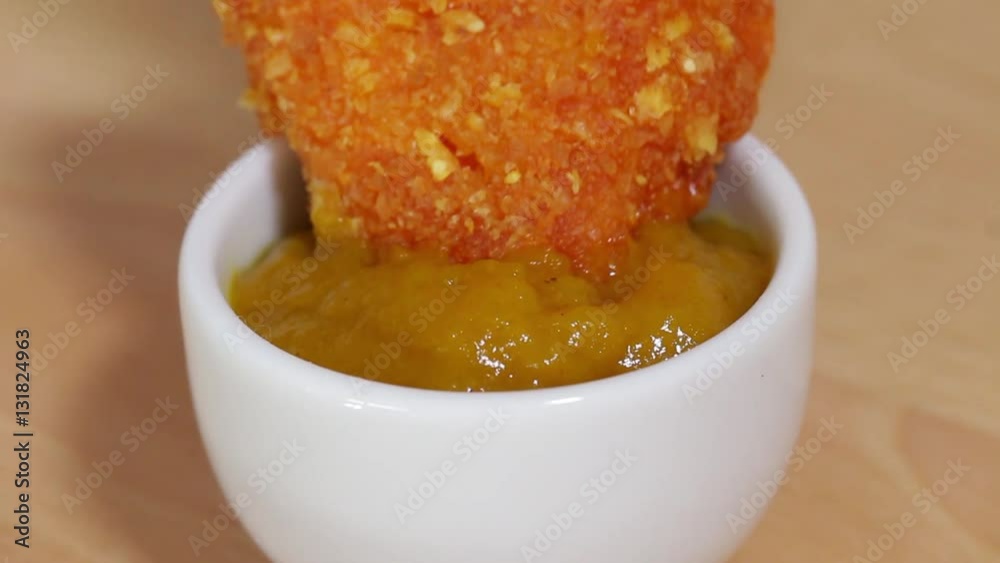 Double Dipping Chicken Crossie into Curry Sauce, Closeup, low focus Double Dipping Chicken Crossie into Curry Sauce, Closeup, low focus