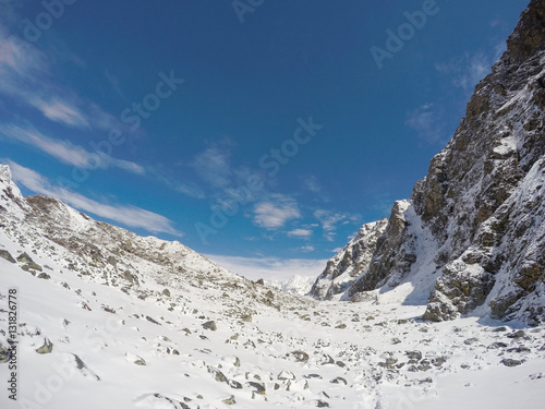 White snow, blue sky and rocky peaks. Nepalese severe winter. Nepal eco travel and extreme sport.