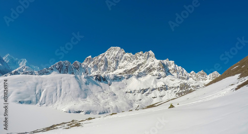 Mountain landscape with rocky ice peaks of Sagarmatha National Park. Severe Nepal winter.