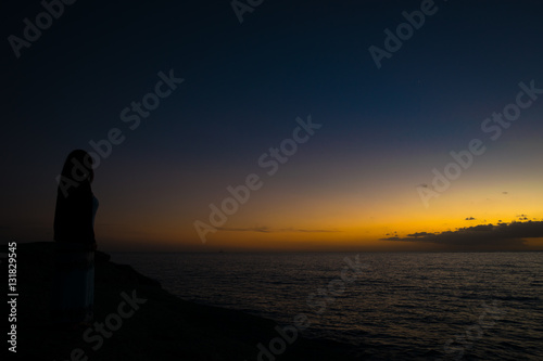 Woman watching the sunset in Tenerife, Spain