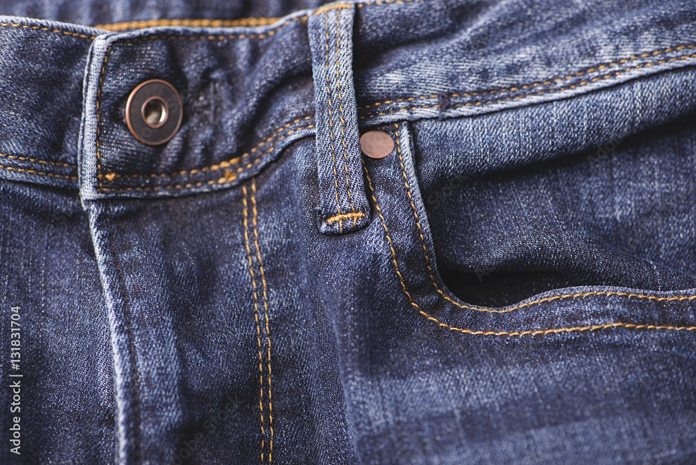 Horizontal shot of a button on a jeans fly Horizontal shot of a button on a jeans fly