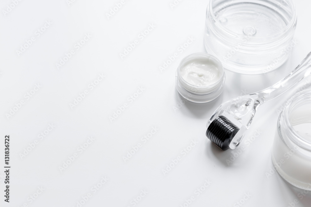 concept cosmetologist desktop with mezoroller - mesotherapy on white background concept cosmetologist desktop with mezoroller - mesotherapy on white background