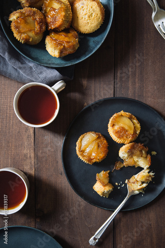 Pear cupcakes and tea on table