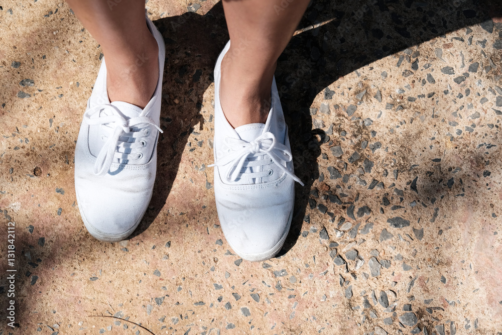 White sneakers on girl legs