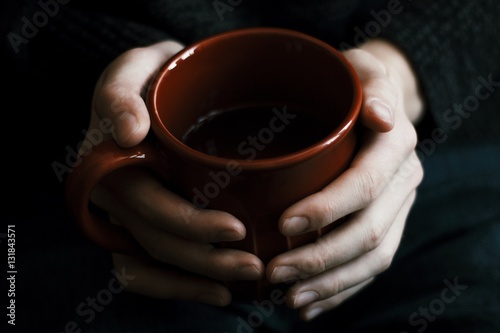 Close-Up of Hands Holding Red Mug
