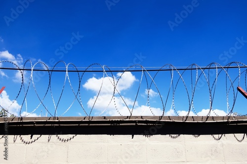 Barbed Wire fence against blue sky