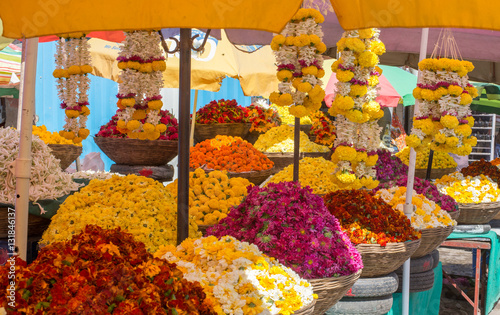 Indian flower market stall with baskets and garlands of marigolds and chrysanthemums