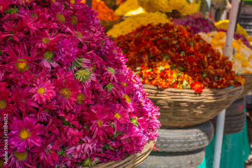 Baskets of chrysanthemums and marigolds at an outdoor market in India
