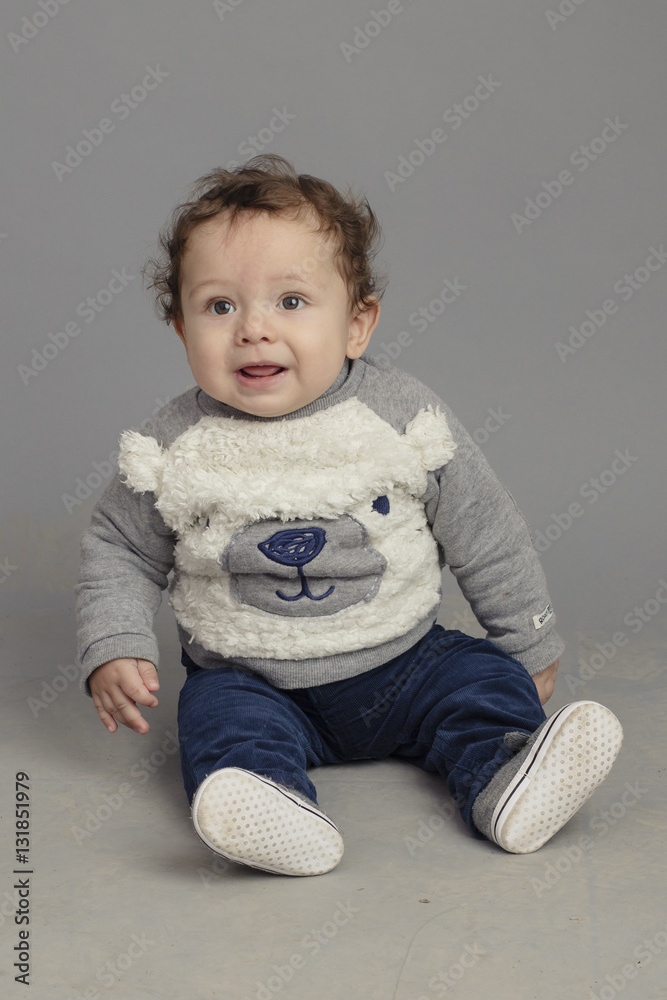 Caucasian baby sitting on stool isolated inside studio Caucasian baby sitting on stool isolated inside studio