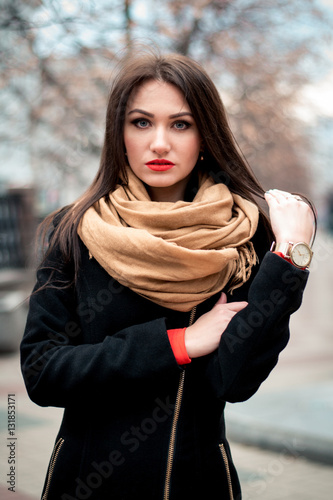 Autumn fashionable portrait of young happy brunette girl red lipstick outdoors in the city