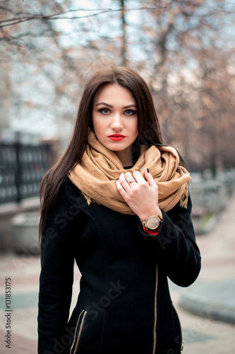 Autumn fashionable portrait of young happy brunette girl red lipstick outdoors in the city