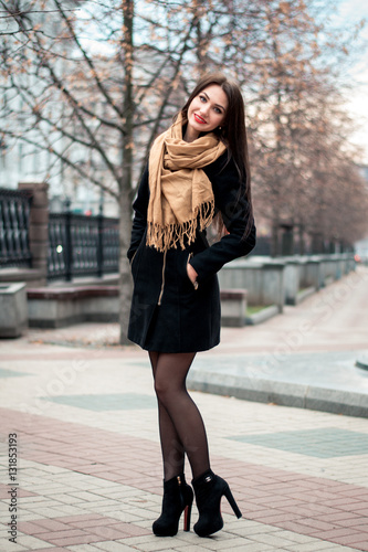 Autumn fashionable portrait of young happy brunette girl red lipstick outdoors in the city