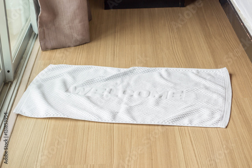 towel fabric doormat on hardwood floor