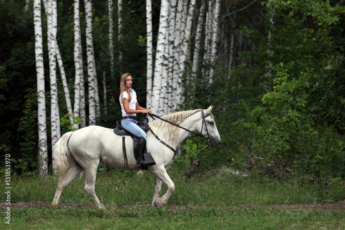 Cowgirl riding horse outdoors