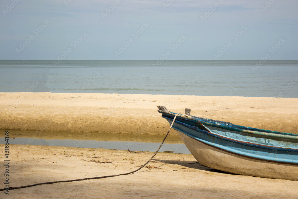 old wood fishing boat on sand beach