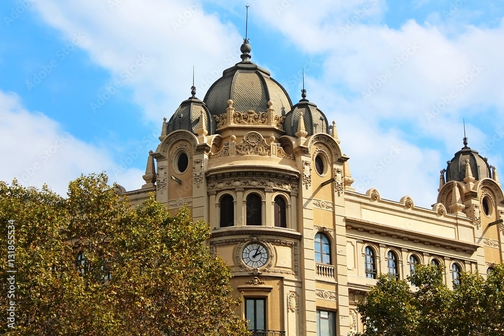 Old building with clock and triple dome, Barcelona, Spain