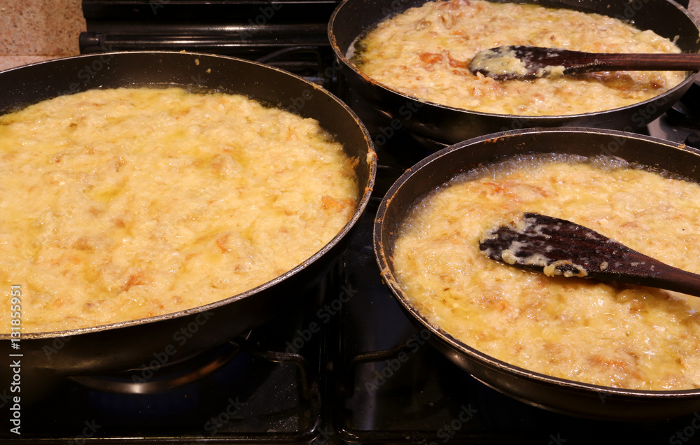 three large pots with FRICO with aged cheese and baked potatoes