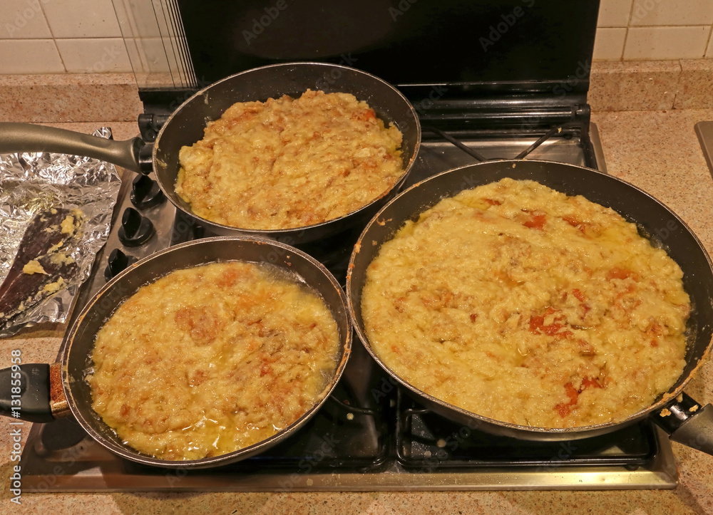 pots with the typical dish called FRICO Of the Italian region pots with the typical dish called FRICO Of the Italian region