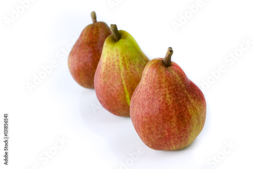 Three ripe pears in a row, isolated on white background. Still-life picture taken in studio with soft-box.