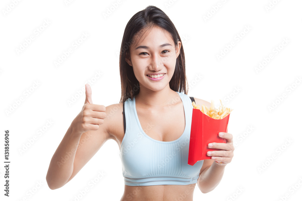 Asian healthy girl eat french fries show thumbs up. Asian healthy girl eat french fries show thumbs up.