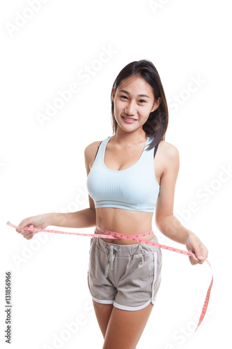 Beautiful Asian healthy girl measuring her waist. © halfbottle