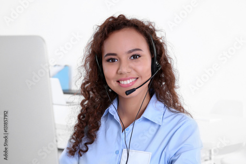 Young female technical support dispatcher working in office, closeup photo