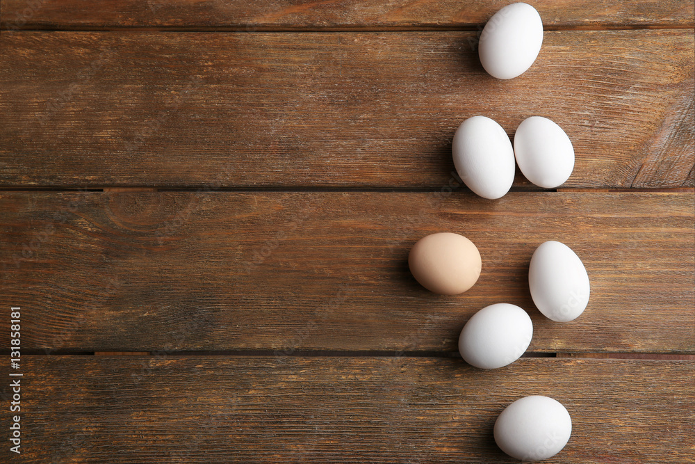 Raw eggs on wooden background, top view Raw eggs on wooden background, top view