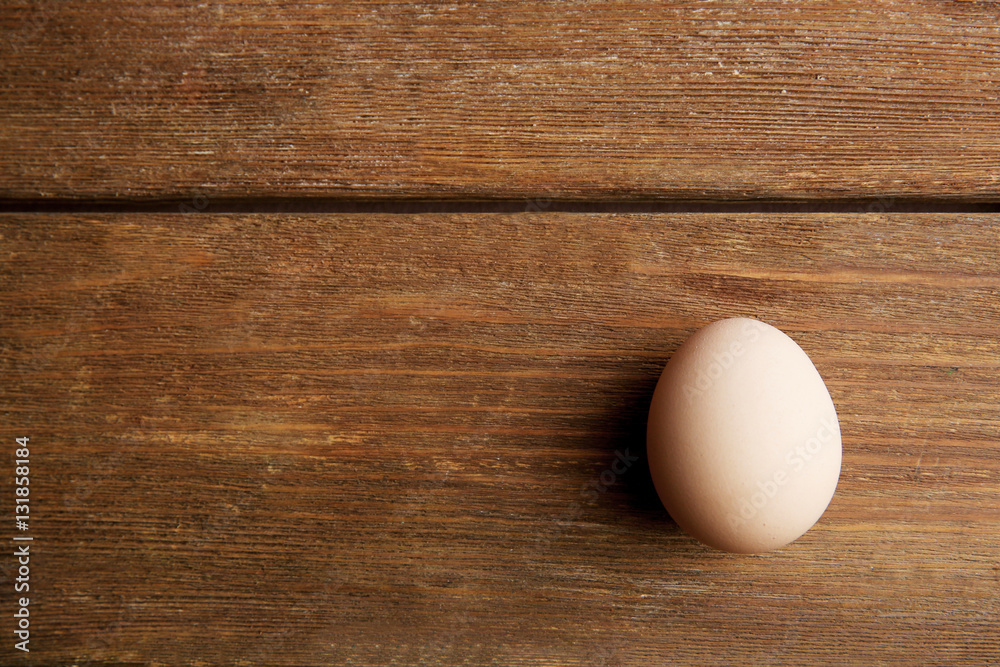 Raw egg on wooden background