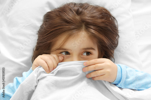 Funny little girl lying in ...