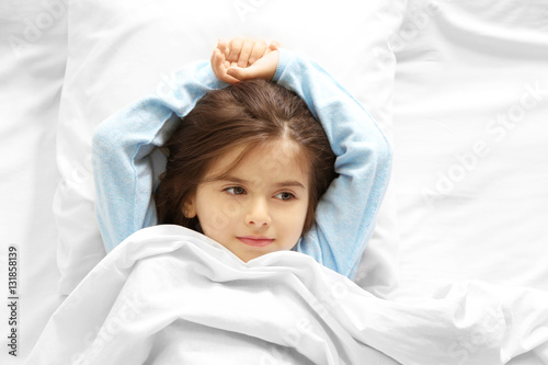 Funny little girl lying in ...
