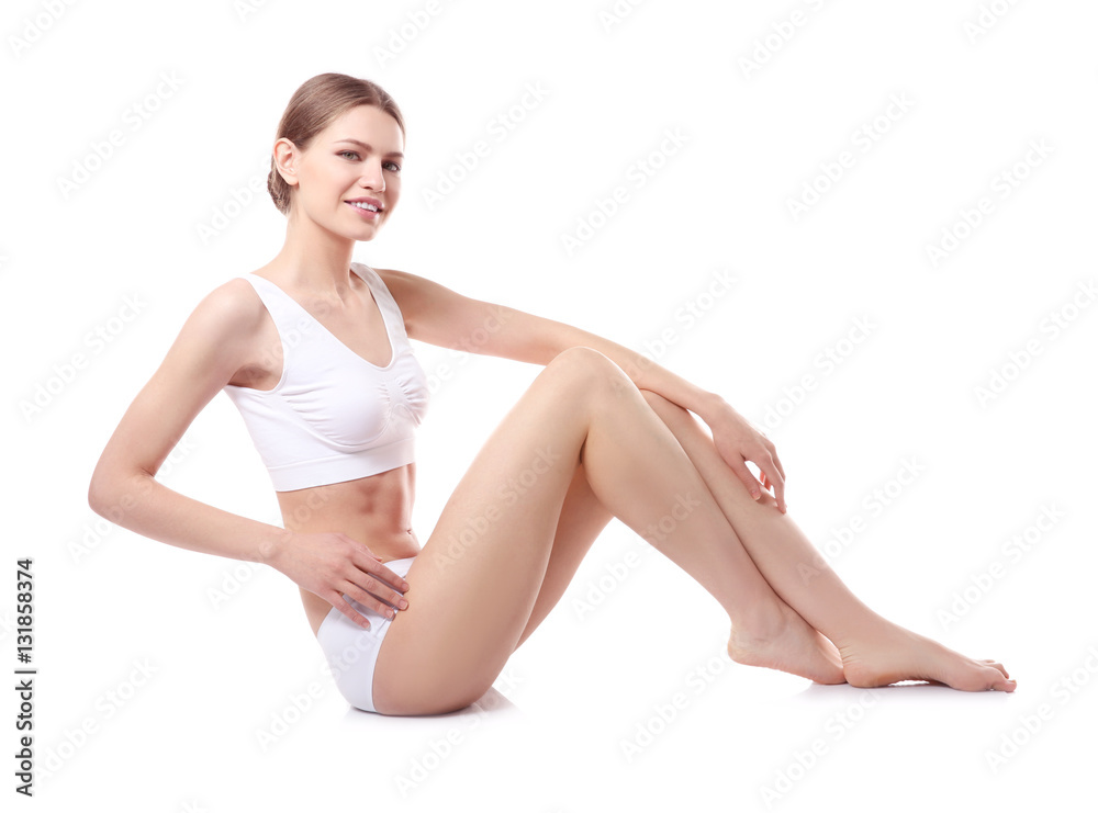 Beautiful young woman sitting on white background Beautiful young woman sitting on white background
