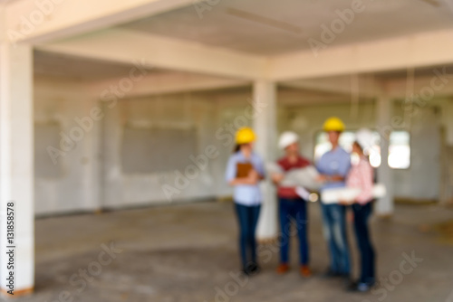 Abstract blurred group of engineers discuss about construction p