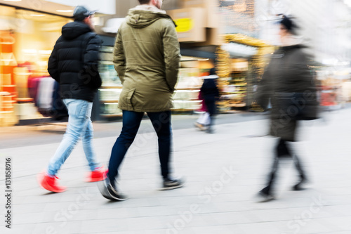 people walking on shopping street with motion blur